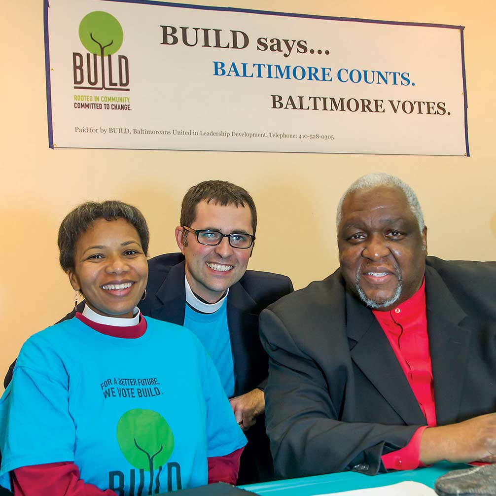 Rev. Andrew Foster Connors and two others at a BUILD event