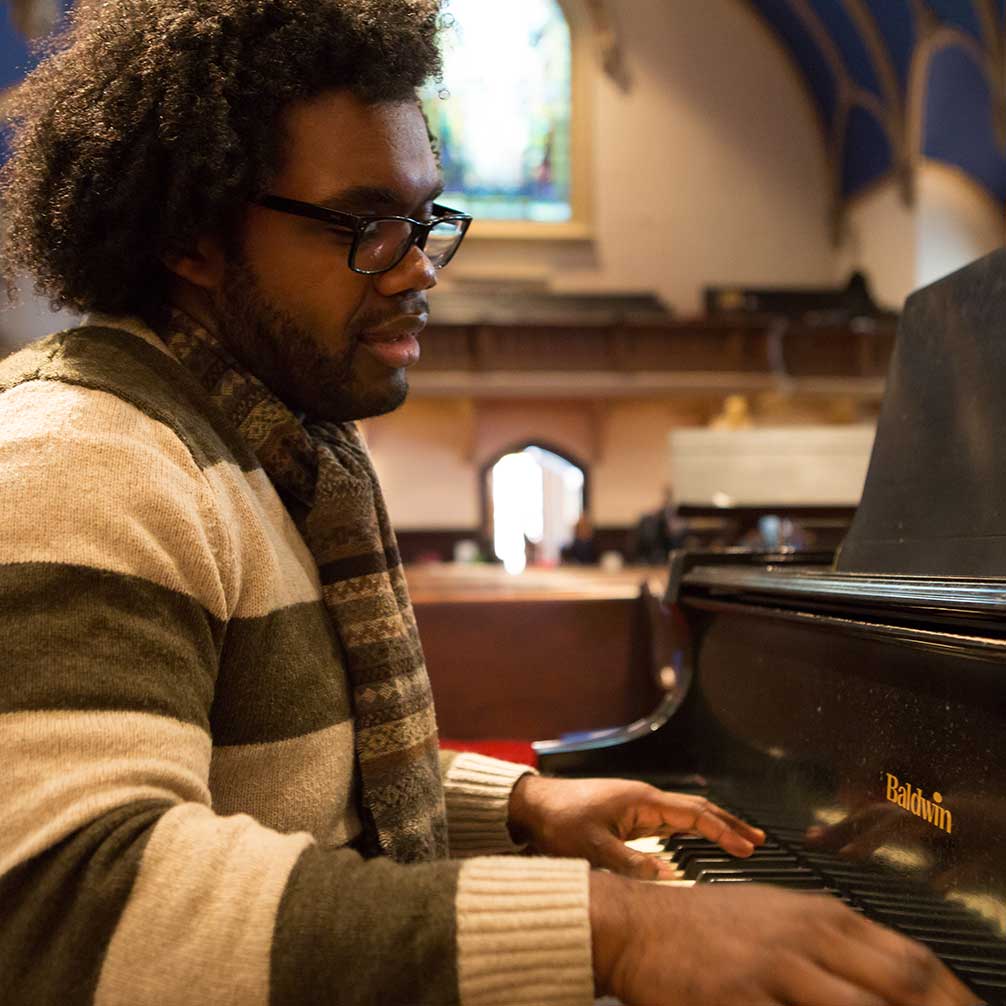 Man plays the piano after worship.