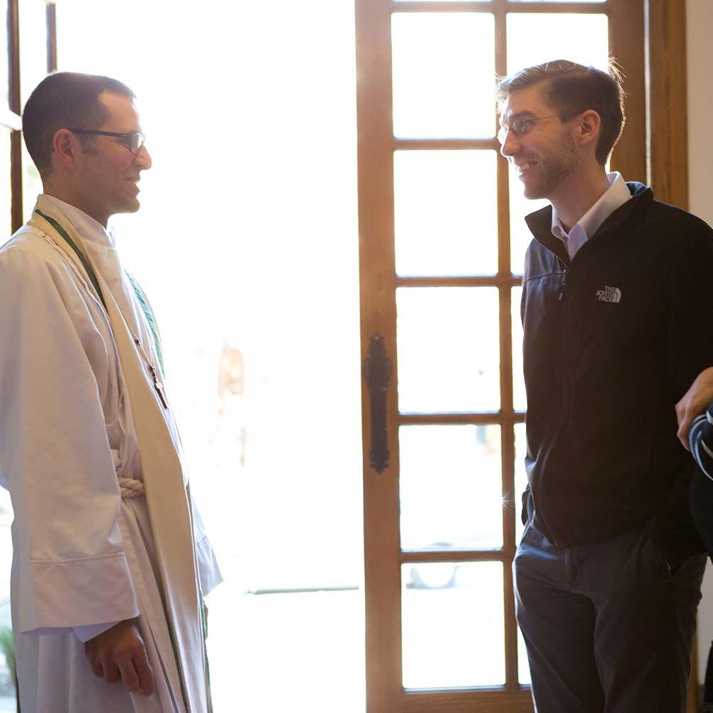 Pastor Andrew Foster Connors greets a visitor to the church