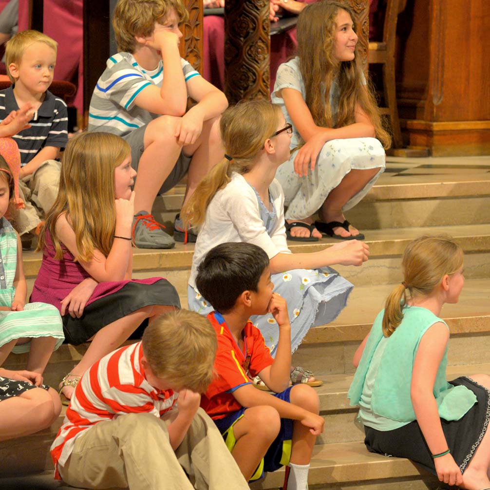 children in the sanctuary listen to a children's message from the pastor