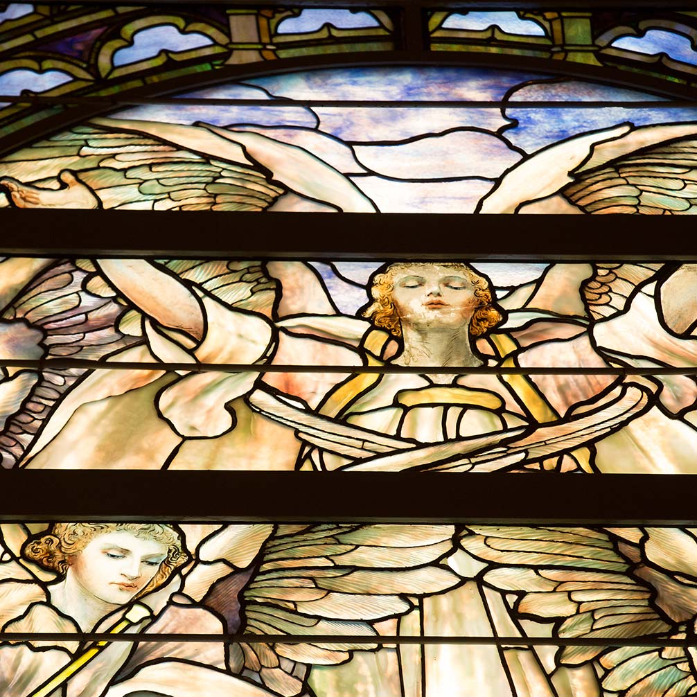 stained glass of an angel with open arms