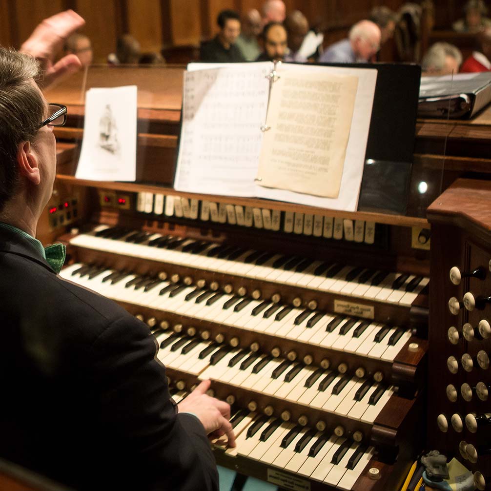 Minister of Music Michael Britt conducts the choir from the console of the EM Skinner organ