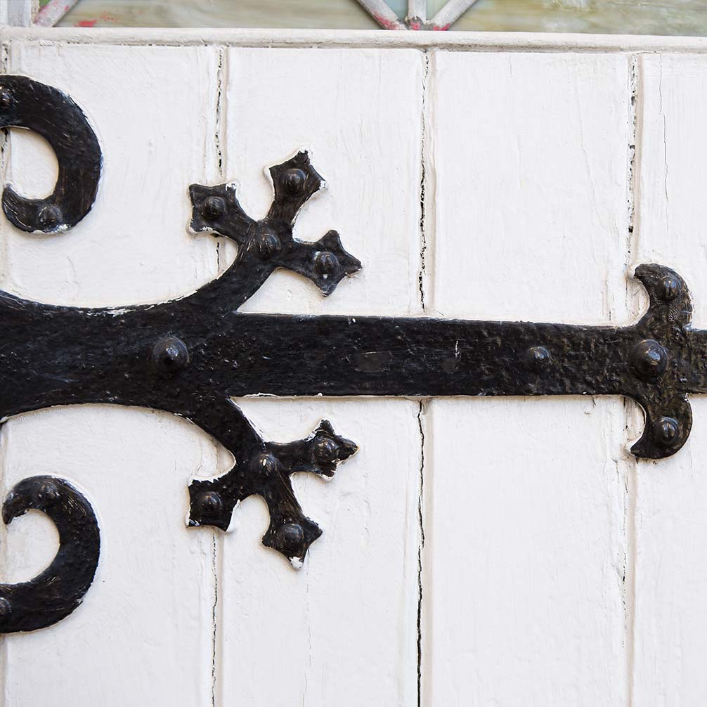 wrought iron hinge detail on a wooden door