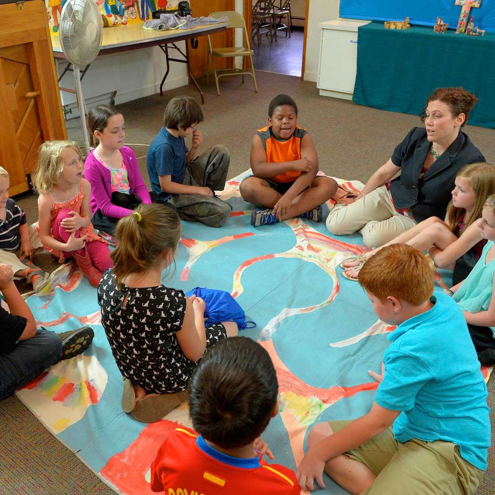 children gather in a circle during sunday school.