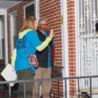BUILD member goes door-to-door to register voters in Baltimore.