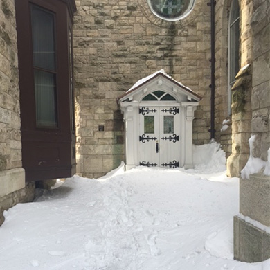 Brown Memorial door entrance covered in snow