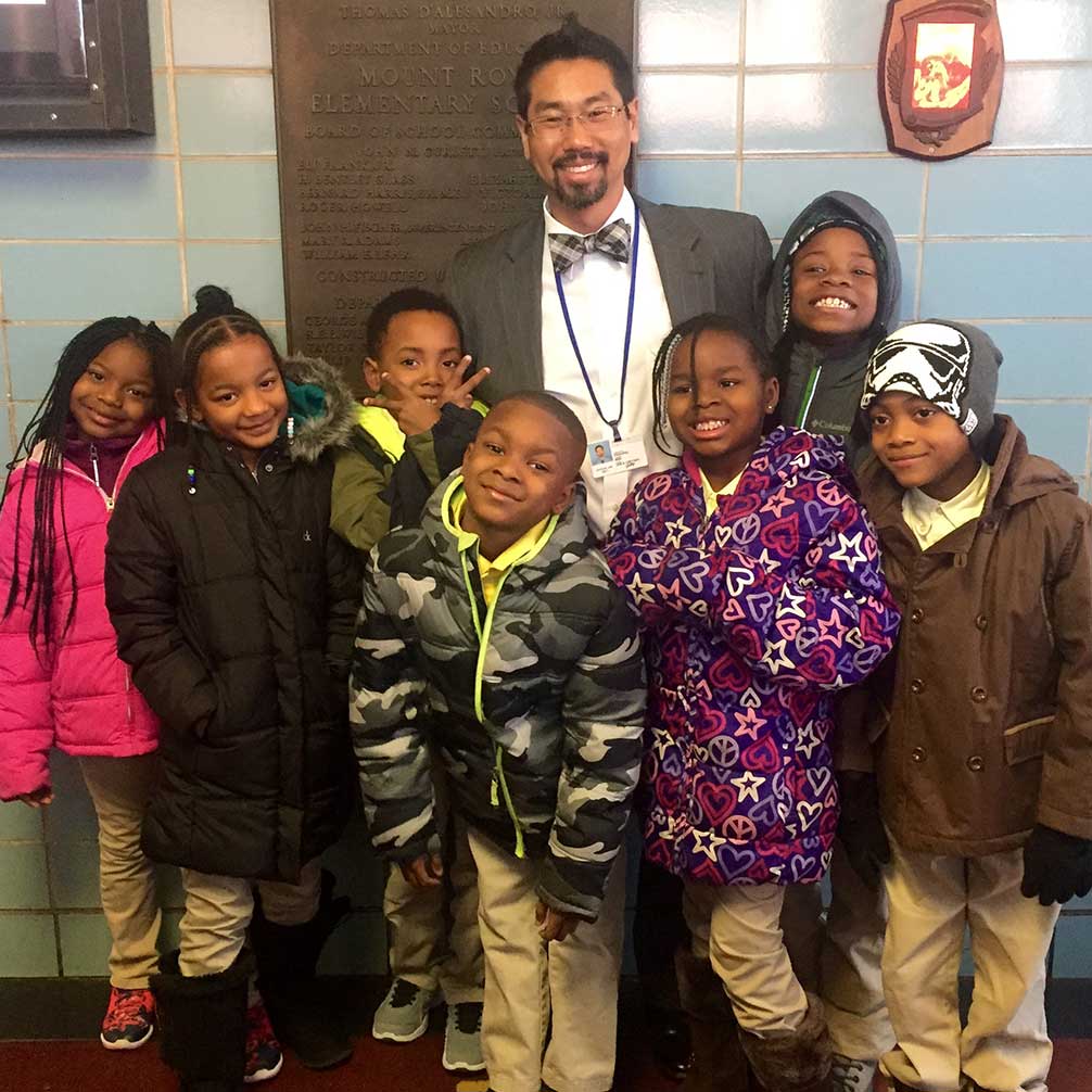 Principal Job Grotsky stands with a group of smiling students at Mt. Royal Elementary.