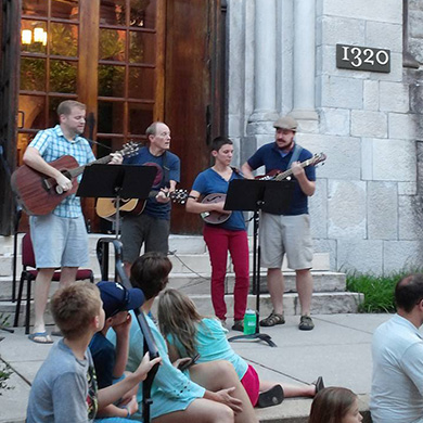 Members of Brown give a concert on the church front steps July 8.
