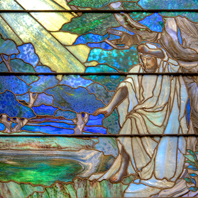 An image of light shining down on Jesus as portrayed in one of Brown's Tiffany windows.
