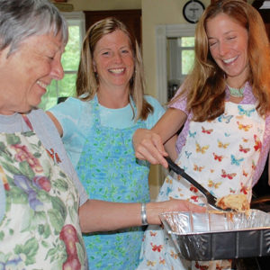 Members of Brown gather in a kitchen to cook a casserole for Our Daily Bread.