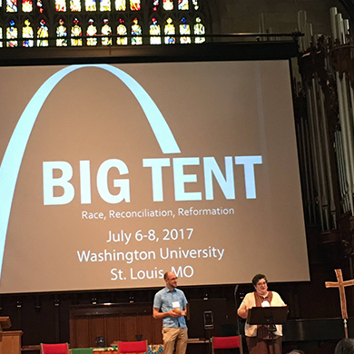 A large screen at Washington University's Graham Chapel displays the words "Big Tent."