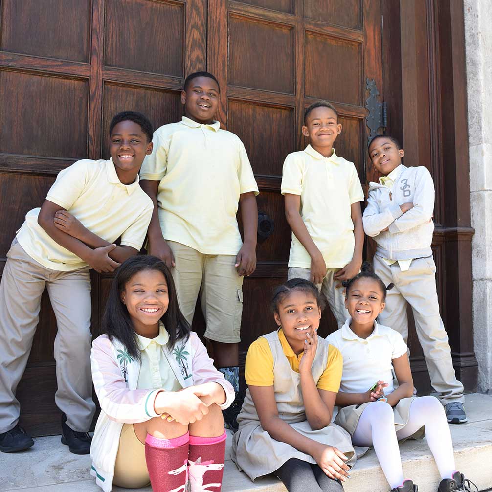 Students in the Brown Memorial Tutoring Program sit on the front steps of the church.