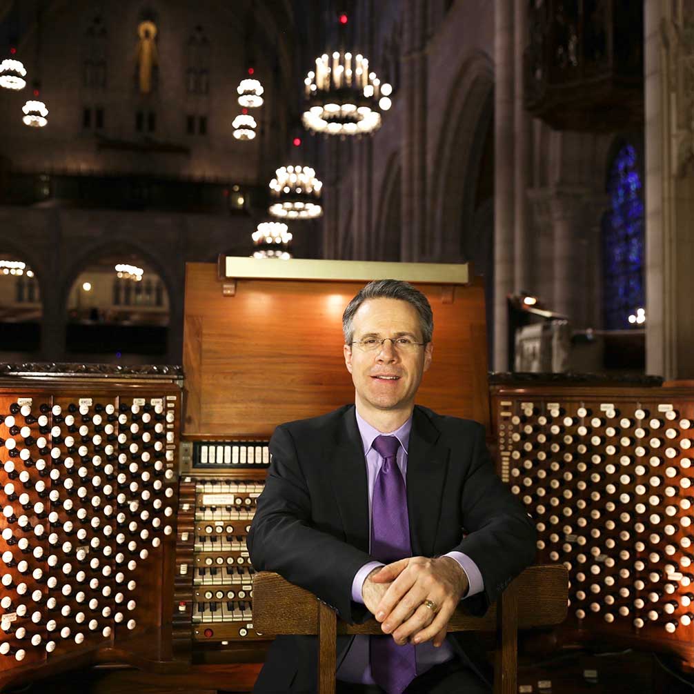 Chris Creaghan sitting at the organ in Riverside Church.