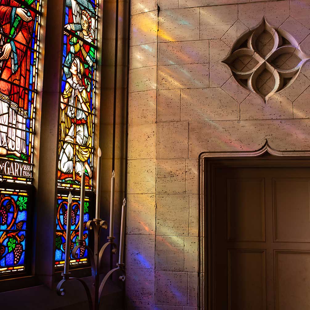 Sun shining through one of the stained glass windows into the sanctuary.