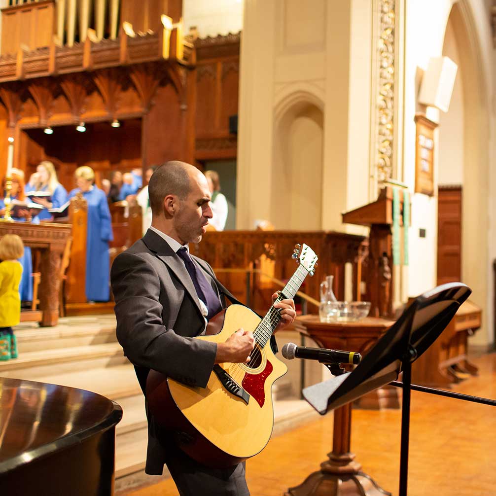 A member of the congregation plays a guitar solo.