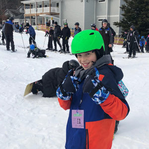 A boy skiing during a youth group outing.